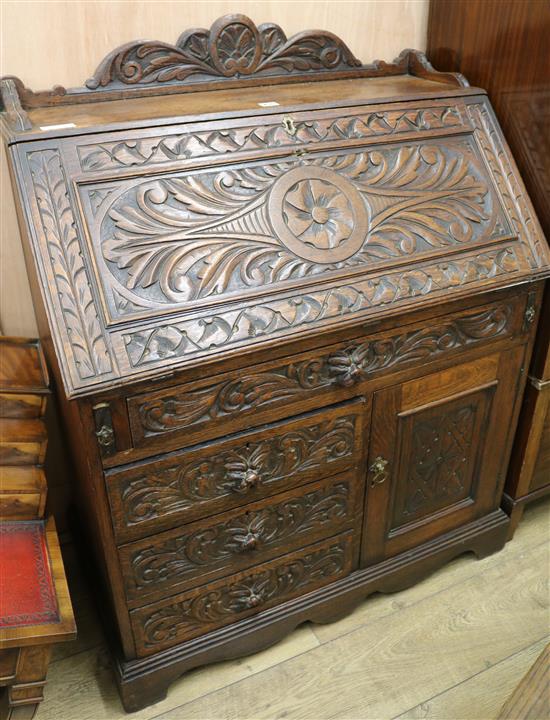 A carved oak bureau, 91cm